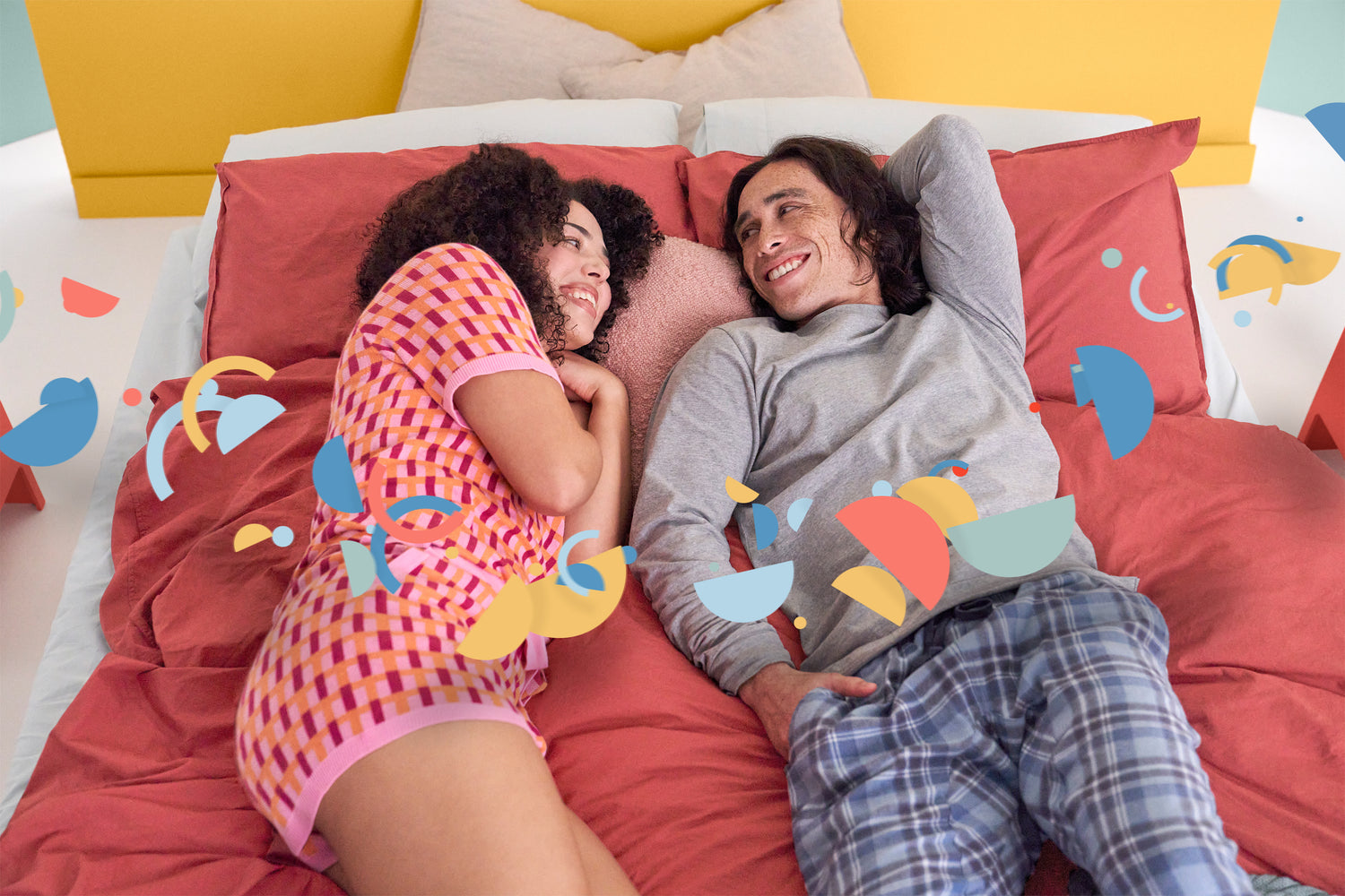 Happy couple lying on the Joy Mattress - Sharing comfort together